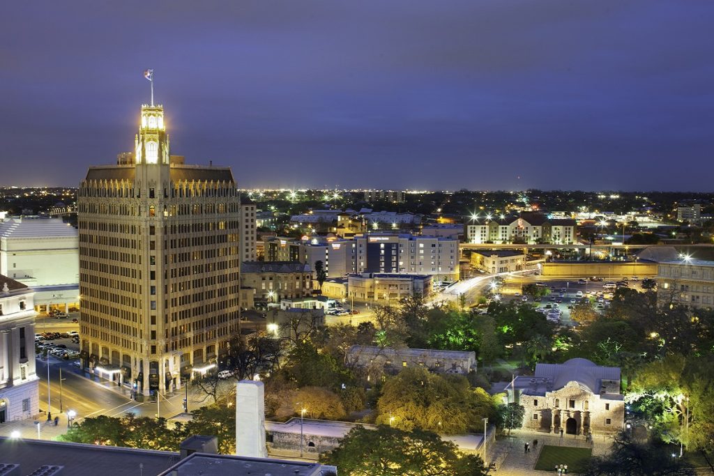 The Emily Morgan hotel towering above the San Antonio skyline at night.