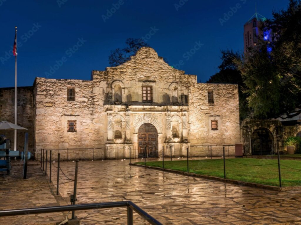 The front of the Alamo at night.